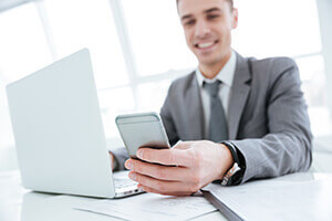 Man smiling at cell phone